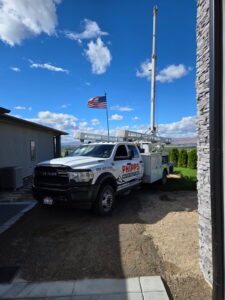 Phipps Water Solutions well pump service truck at a residential property